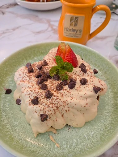 House tiramisu with chocolate chips and a strawberry