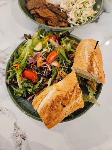 Toasted baguette sandwich with a garden salad